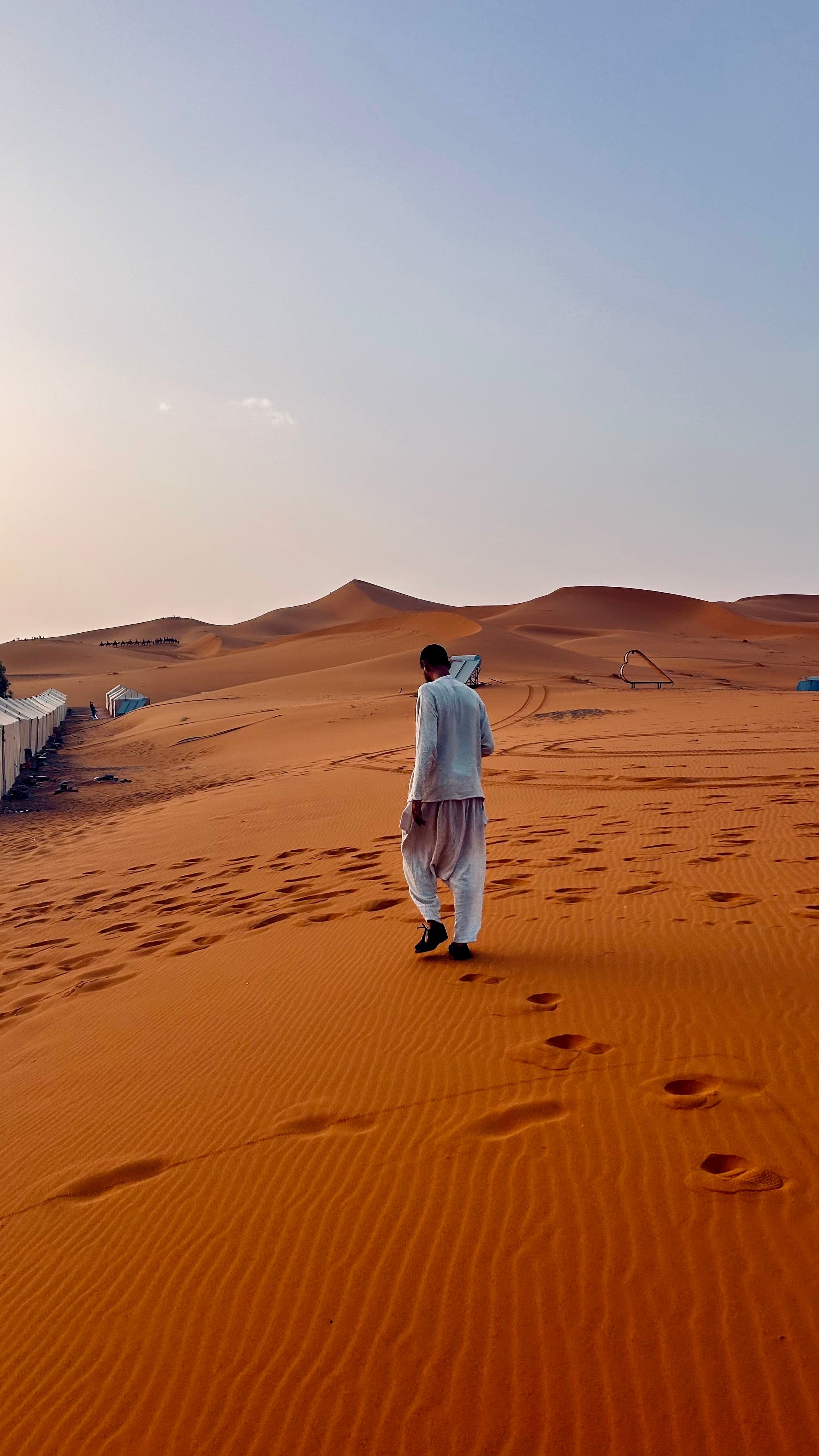 Abdel walking across the dunes of the Moroccan Sahara